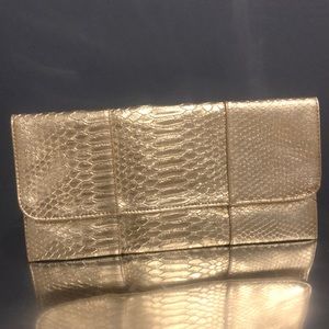 U E gold color looks like snake skin clutch